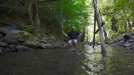 Swinging-on-a-swing-at-the-creek-in-slow-motion.